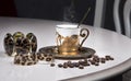 Golden coffee cup, beans and jewelry on table, luxurious elegance style concept