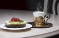 Golden coffee cup and berry tartlet or fruits cake on table in cafe, luxurious elegance style  concept Royalty Free Stock Photo