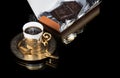Golden coffee cup with reflection and chocolate bar isolated on black background. Copy space for text. Luxurious elegance style Royalty Free Stock Photo