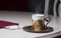 Golden coffee cup, restaurant bill, cash euro on table in cafe, luxurious elegance style