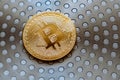 Golden Coin of Digital Currency Bitcoin Closeup