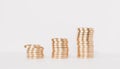 Golden coin stacks growing graph on white background, business investment and saving money concept, realistic 3d render Royalty Free Stock Photo