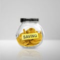 Golden coins in a glass jar and note paper with saving text on a white table Royalty Free Stock Photo