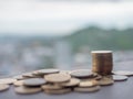 Golden coins, residential and mountain view background, investment concept Royalty Free Stock Photo