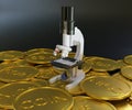 close up golden coins scattered with scientific microscope