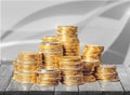 Golden coins stacks on wooden table