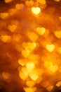 Golden color heart bokeh background photo. Abstract holiday, celebration backdrop. Royalty Free Stock Photo