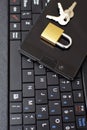 Golden color locked padlock keys and black smartphone on keyboard Royalty Free Stock Photo