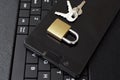 Golden color locked padlock keys and black smartphone on keyboard Royalty Free Stock Photo