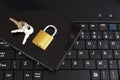 Golden color locked padlock keys and black smartphone on keyboard Royalty Free Stock Photo