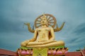 Golden color statue of buddha in the temple during cloudy day. Thailand Royalty Free Stock Photo