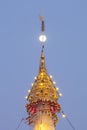 A golden color of top roof pagoda decorated by lighting at night time