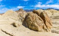 Golden Colored Badlands Formation With The Black Mountain Range Royalty Free Stock Photo