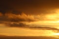 Golden colored clouds in sunset sky Royalty Free Stock Photo