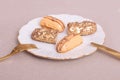 Golden colored eclairs on plate with fork and knife