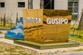 Golden colored location sign of Gusipo port