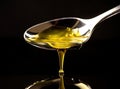 A golden colored olive oil being poured from a spoon isolated on the background. Generative AI