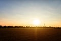 Golden and colorful sunset over the freshly plowed field, cereal fields with lens flare Royalty Free Stock Photo