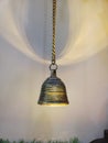 Golden colour antique vintage hinging bell clousup photo with nice background of shedding light