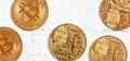 Golden commemorative btc - bitcoin cryptocurrency - coins scattered on white stone board, closeup detail from above