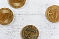 Golden commemorative EOS - EOSIO cryptocurrency - coins on white stone board, flat lay view