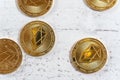 Golden commemorative EOS - EOSIO cryptocurrency - coins on white stone board, view from above