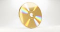 Golden Compact Disc on White Background with Light Reflection Royalty Free Stock Photo