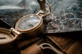 Golden compass on tactical or travel backpack, shallow DOF, focus on dial. Concept for direction, travel, guidance or assistance
