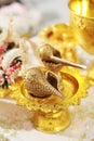 A golden conch set and flower garlands for Thai water pouring wedding c