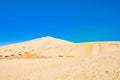 Golden cones of Giant sand dunes under cloudless blue sky. Te Paki, Northland, Far North, New Zealand Royalty Free Stock Photo