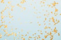 Golden confetti on a festive blue background