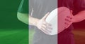 Golden confetti and italy waving flag against caucasian male rugby player holding a rugby ball Royalty Free Stock Photo