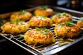 golden cooked crab cakes on a cooling rack