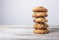 Golden cookie tower with pieces of chocolate on wooden background Royalty Free Stock Photo