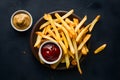 Golden crispy fries temptingly served with sauce on a dark background