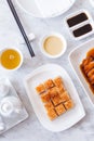 Golden Crispy Pork Belly cut in cube served with mustard sauce and hot tea with chopsticks Royalty Free Stock Photo