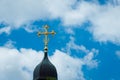 Golden cross of the Christian temple on the background of the cloudy sky Royalty Free Stock Photo