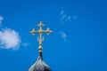 Golden cross of the Christian temple on the background of the cloudy sky Royalty Free Stock Photo