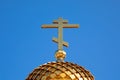 Golden cross and dome of the Orthodox Church against the blue sky. Royalty Free Stock Photo