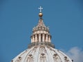 Golden cross on the dome of the Papal Basilica of Saint Peter under clear blue sky in the Vatican Royalty Free Stock Photo