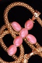 Golden cross necklace with precious pink gems Royalty Free Stock Photo