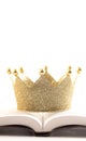 A Golden Crown on a Holy Bible on a White Background Royalty Free Stock Photo