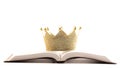 A Golden Crown on a Holy Bible on a White Background Royalty Free Stock Photo