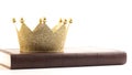 A Golden Crown on a Holy Bible on a White Background Royalty Free Stock Photo