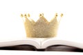 A Golden Crown on a Holy Bible on a White Background Royalty Free Stock Photo