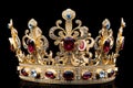 Golden crown inlaid with precious stones isolated on a black background. Royal decoration Royalty Free Stock Photo