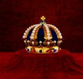 Golden Crown with jewels, pearls. Standing on velvet Royalty Free Stock Photo