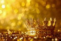 Golden crown with jewels on it sits on top of bed of gold confetti. Generative AI Royalty Free Stock Photo