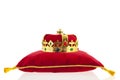 Golden crown on velvet pillow