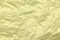 Golden crumpled paper background. Yellow crease paper texture. Copy space. Place for text Royalty Free Stock Photo